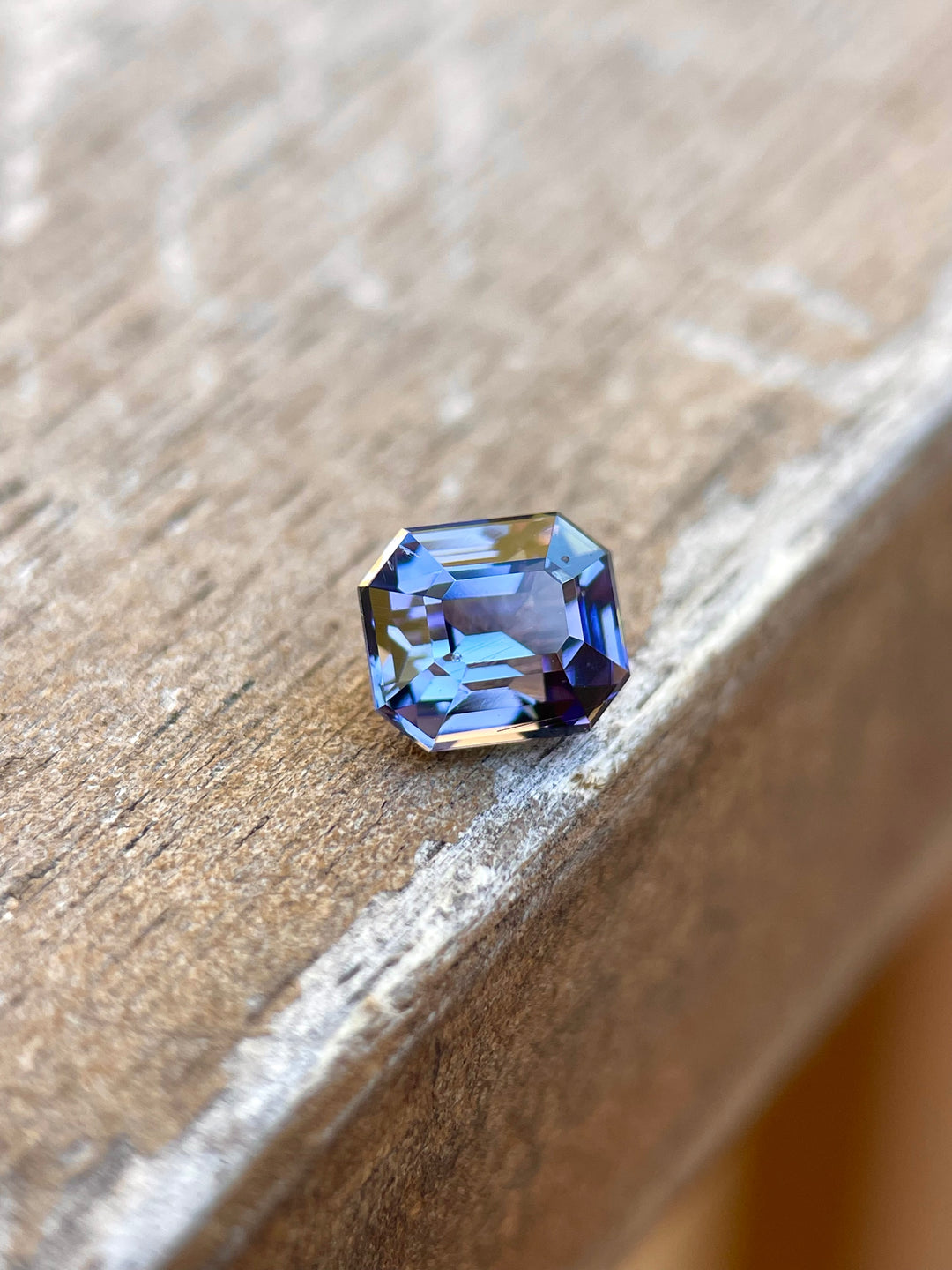 Custom Modified Emerald Cut Tanzanite Gemstone in Teal, Blue, Green, and Purple Colors, Weighing 1.32 Carats, with Dimensions 6.49 x 5.58 x 4.60 mm, Originating from Merelani Hills, Arusha Region, Tanzania - No Treatment