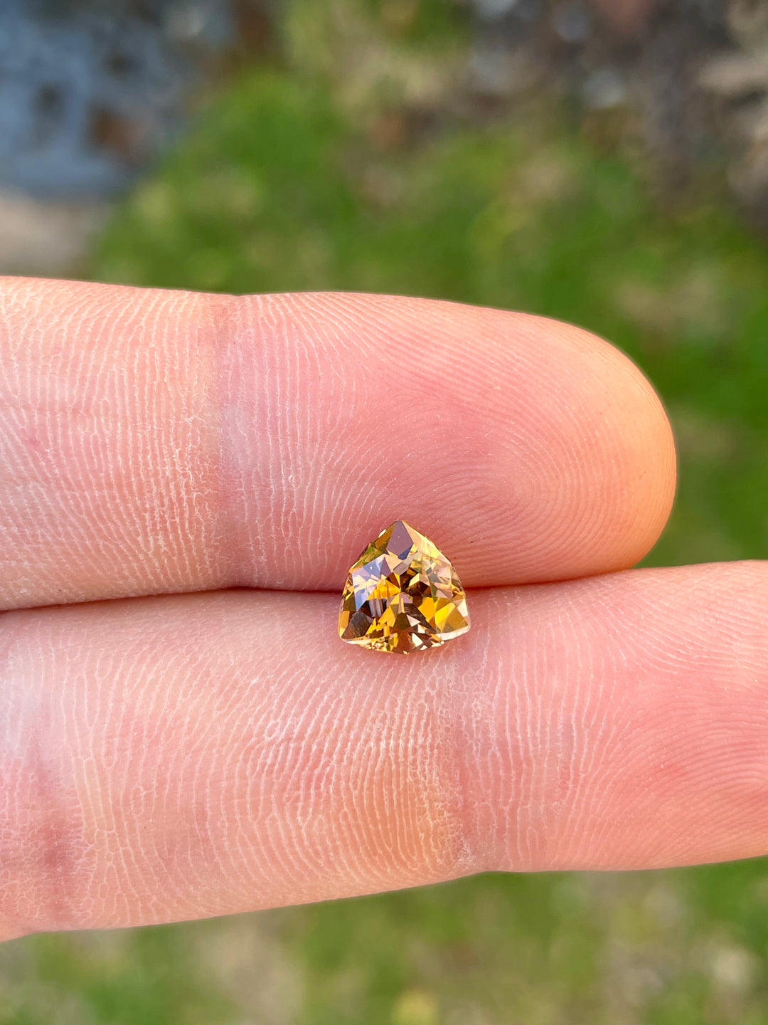 High-Resolution Image of a Custom Trilliant Cut Tanzanite Gemstone in Vivid Peach Orange Color, Weighing 2.01 Carats, with Dimensions 8.06 x 8.14 x 5.32 mm, from Merelani Hills, Arusha Region, Tanzania - No Treatment