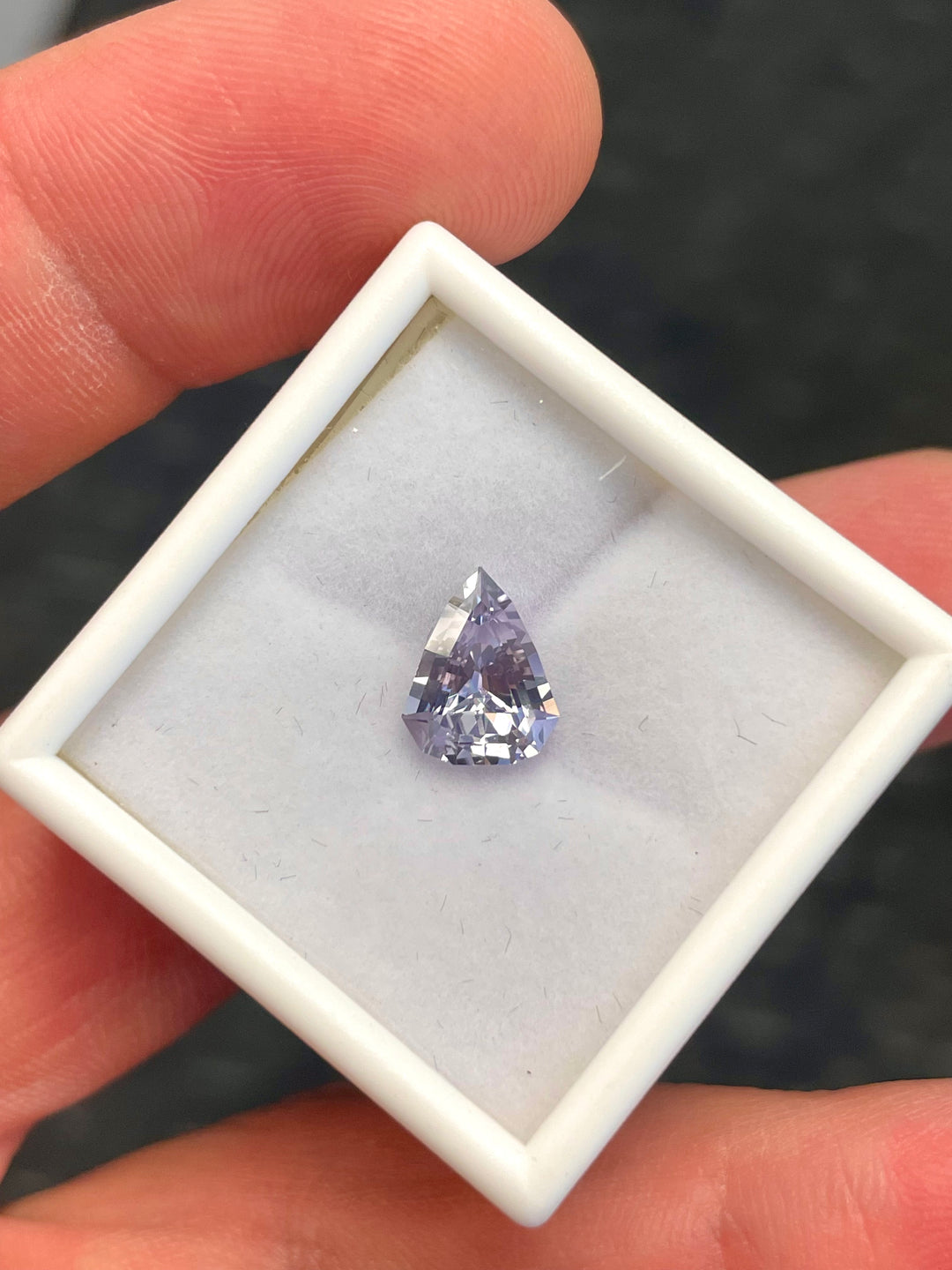 Image of a Custom Modified Shield Cut Sapphire Gemstone in Color Shift from Pale Lavender to Pale Blue, Weighing 2.44 Carats, with Dimensions 10.33 x 8.17 x 4.76 mm, Originating from Sri Lanka - No Heat Treatment