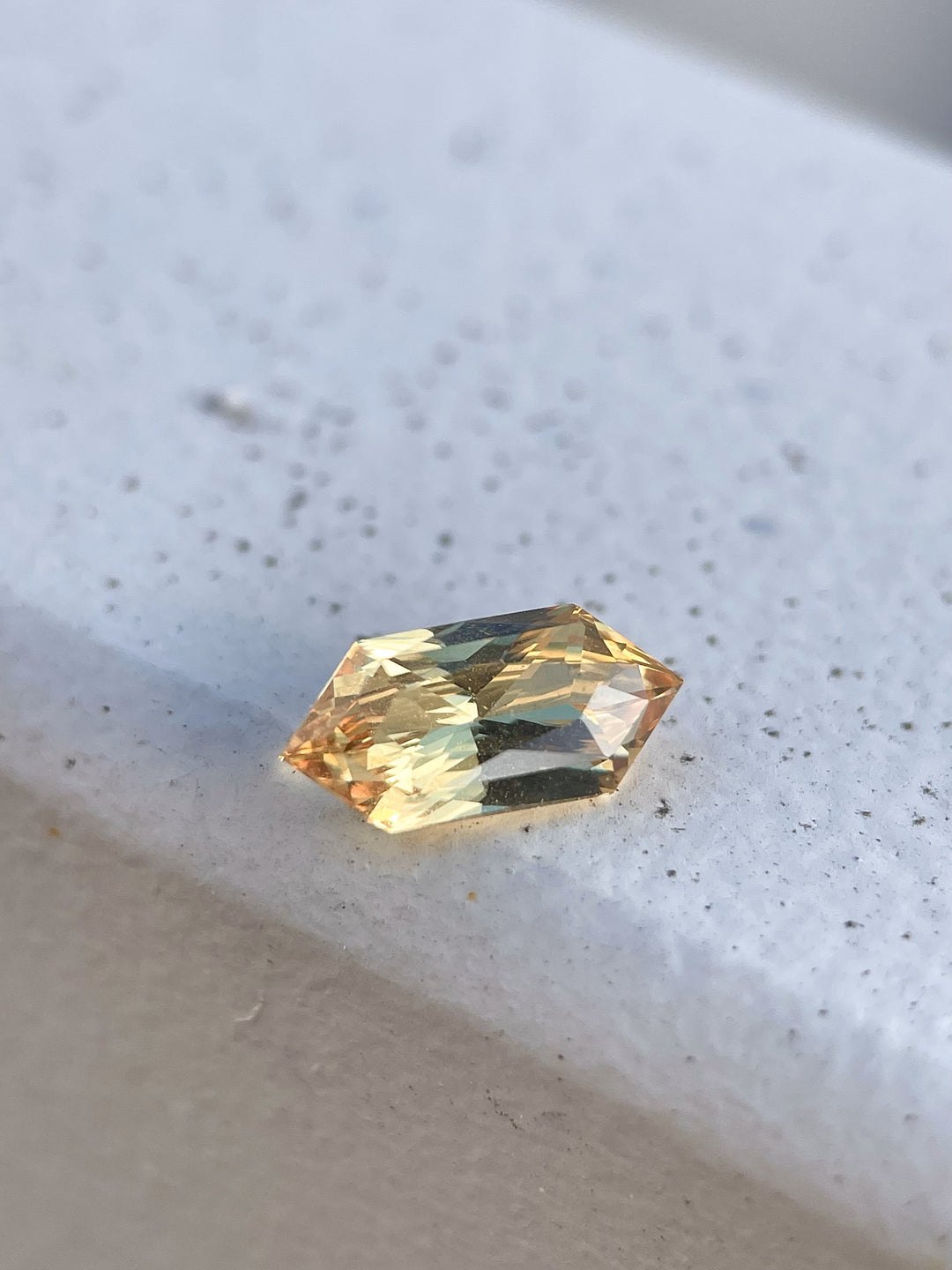 A vibrant 2.01-carat lemon yellow sapphire with a modified brilliant hexagon cut. Ethically sourced from Sri Lanka, this untreated gemstone radiates a warm and sunny hue.