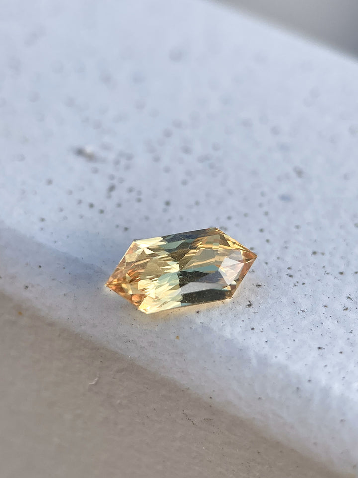 A vibrant 2.01-carat lemon yellow sapphire with a modified brilliant hexagon cut. Ethically sourced from Sri Lanka, this untreated gemstone radiates a warm and sunny hue.