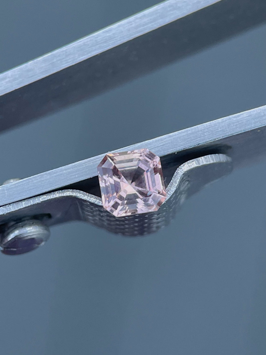 Detailed view of a 0.56-carat Montana sapphire with crisp step-cut facets, highlighting its natural beauty and untreated clarity.