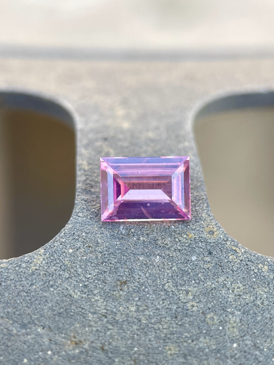 Stunning 1.10 carat emerald cut sapphire, displaying rich hues of pink, purple, and mulberry, measuring 6.95 x 5.00 x 2.97 mm, sourced from Sri Lanka, untreated.
