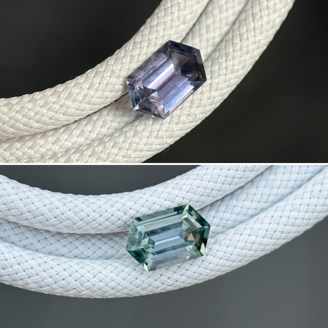 Unheated Montana sapphire displayed on white braided cord, highlighting elongated hexagon step cut geometry and color shift from pale seafoam green to subtle lavender purple