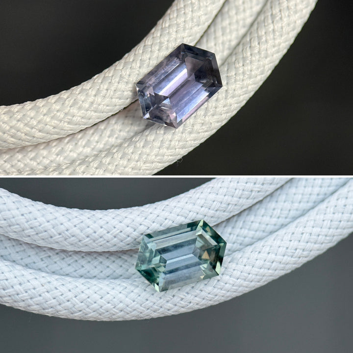 Unheated Montana sapphire displayed on white braided cord, highlighting elongated hexagon step cut geometry and color shift from pale seafoam green to subtle lavender purple
