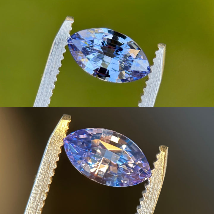 Close-up of 1.70CT natural sapphire held in gemstone tweezers under natural light, showing vivid cornflower blue and violet hues with marquise mixed cut facets, no-heat sapphire from Madagascar.