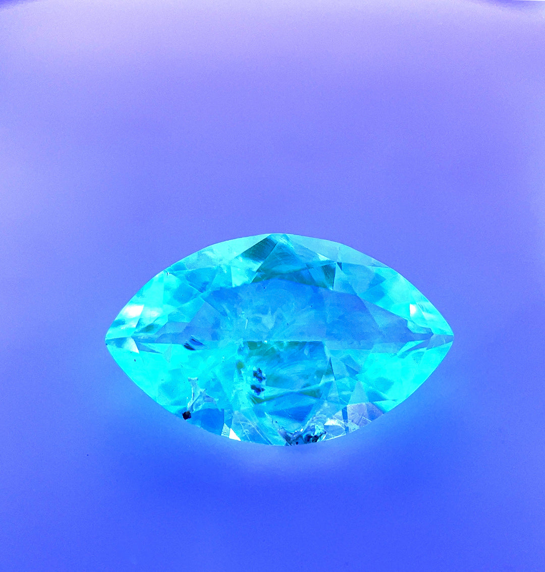 2.18ct Hyalite Opal glowing under UV light, revealing its striking green fluorescence.