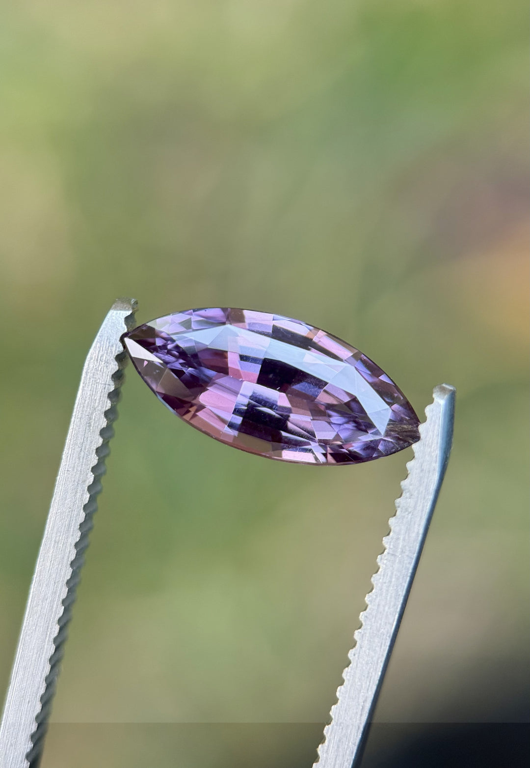 Natural untreated pink-purple sapphire, 3.06CT marquise brilliant cut from Madagascar, reflecting vibrant color play and precision faceting.