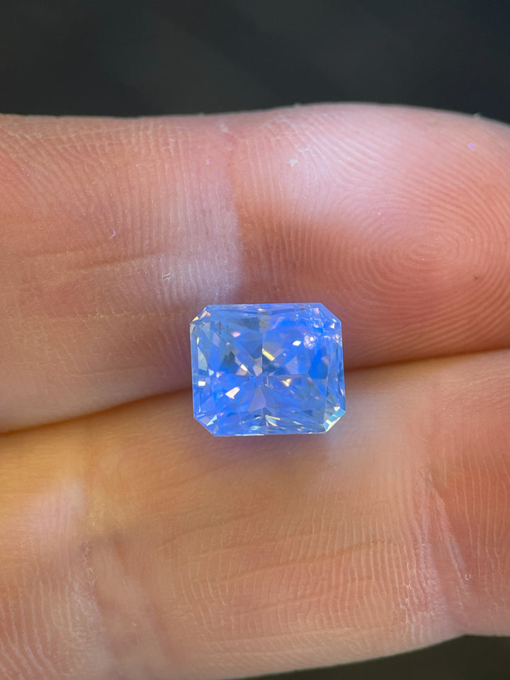 Close-up of a 3.68-carat radiant cut fancy brown-yellow diamond, highlighting its intricate faceting and golden undertones.