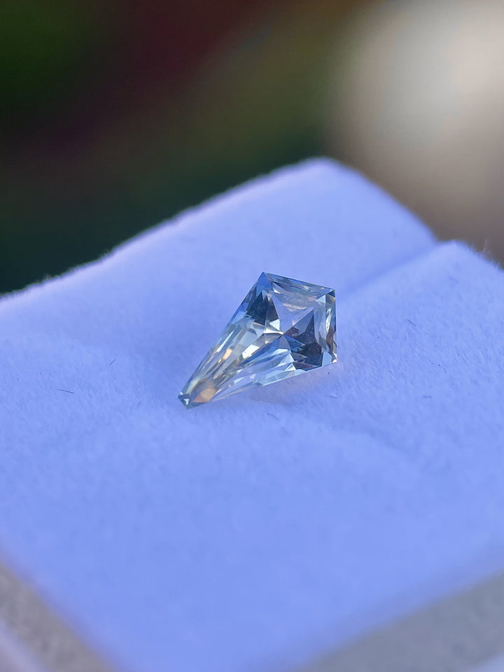 1.20 carat yellow and cornflower parti sapphire, custom mix kite cut, elegantly placed in a natural setting, emphasizing its clarity and vibrant coloring, untreated from Sri Lanka.