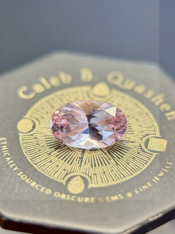 1.50ct untreated sapphire displayed on Caleb B. Quashen gemstone box, showcasing oval modified brilliant cut