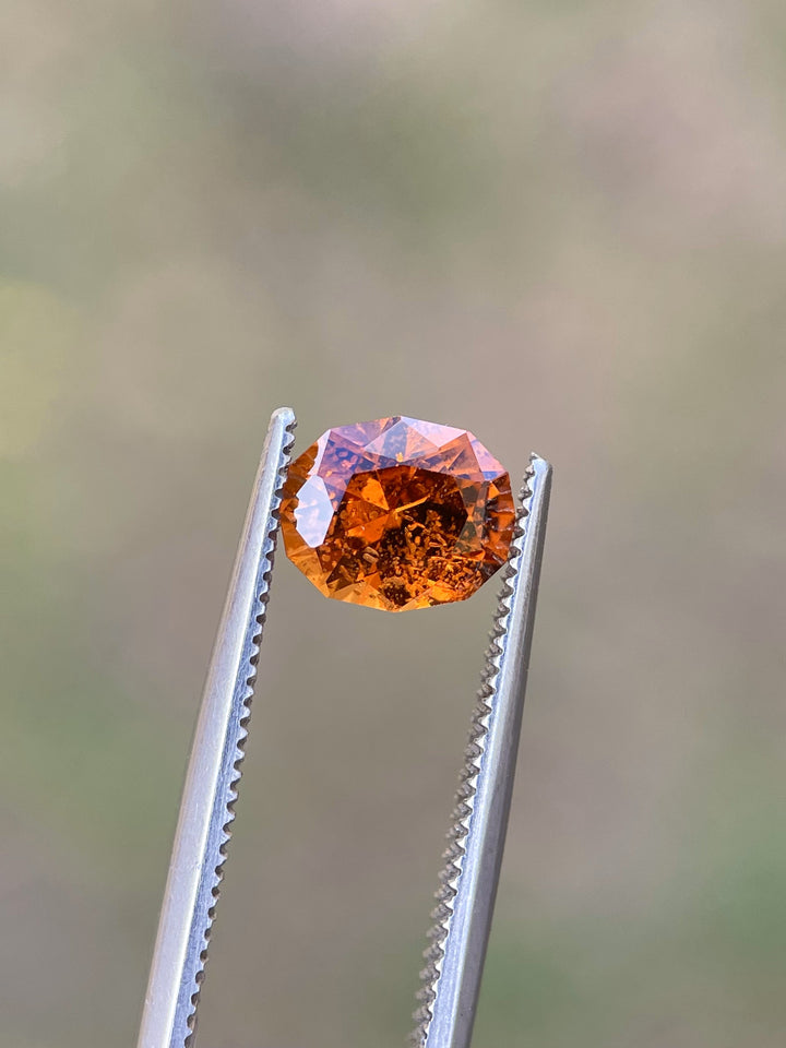 Natural Hessonite Garnet featuring a custom oval cut, weighing 1.61 carats, and showcasing an orange-brown hue from Kenya.