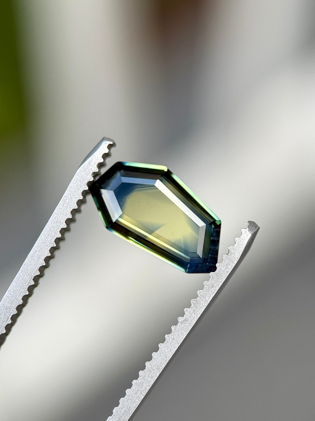 Close-up of a gemstone on a metallic surface with a blurred background