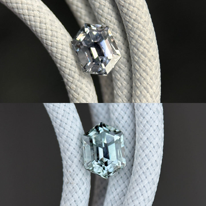 Precision elongated hexagon Montana sapphire resting on braided cord, displaying color shift from pale seafoam green to soft grey silver under mixed lighting, 1.22 carats, untreated natural sapphire.