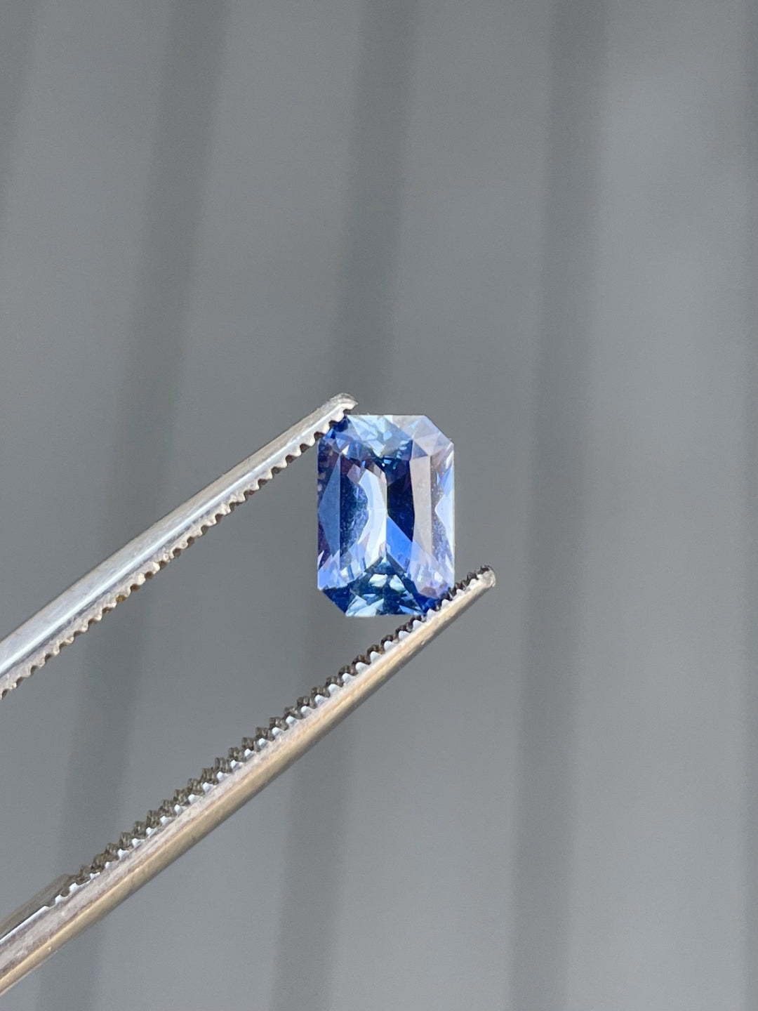 1.10 carat radiant cut sapphire gemstone with vibrant blue-lavender tones, untreated and of Sri Lankan origin.