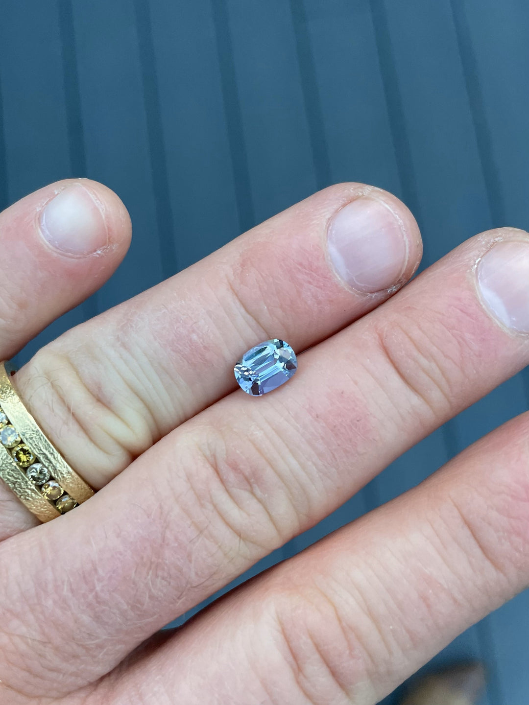 Side-angle view of a cushion-cut 1.36ct Tanzanite, highlighting its clarity, precision faceting, and natural beauty from Tanzania.