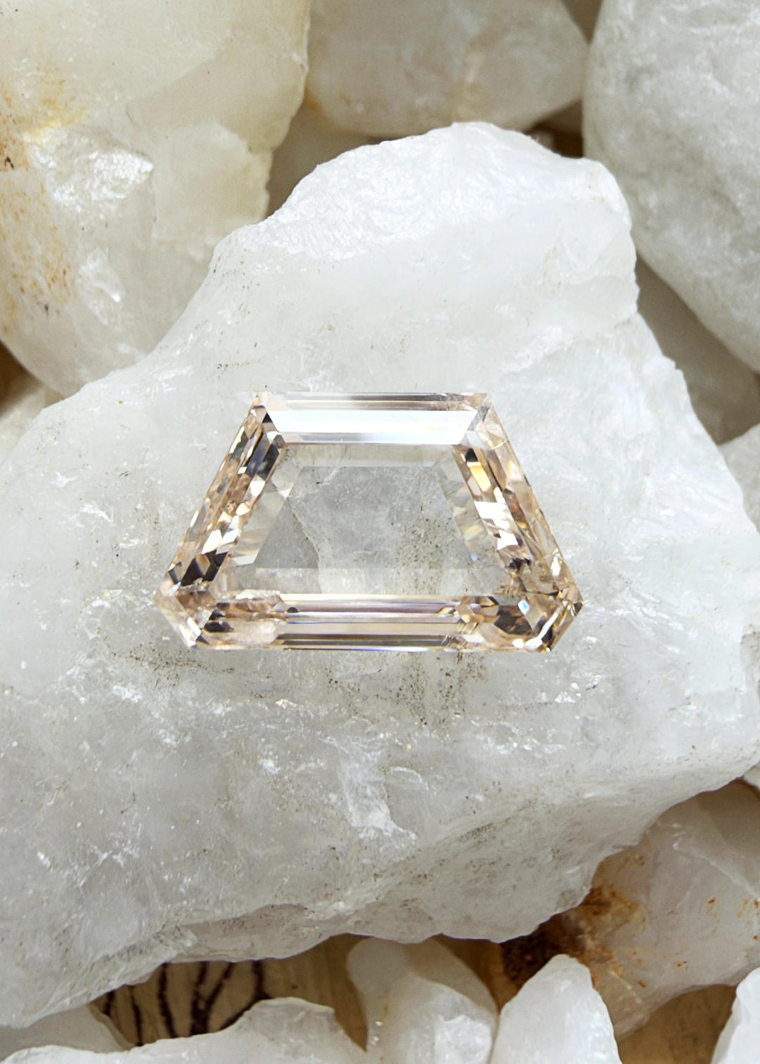 A 0.74-carat Fancy Orangy Pink portrait cut diamond with SI1 clarity, featuring a distinctive pink color modified by warm orange tones. A unique loose diamond for bespoke fine jewelry.