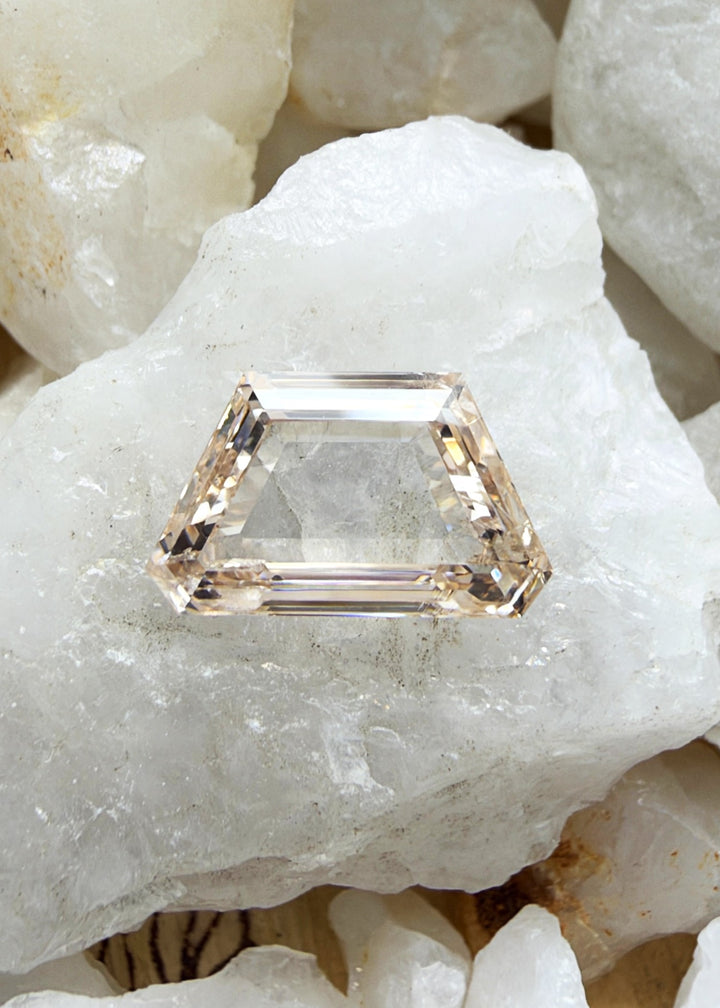 A 0.74-carat Fancy Orangy Pink portrait cut diamond with SI1 clarity, featuring a distinctive pink color modified by warm orange tones. A unique loose diamond for bespoke fine jewelry.