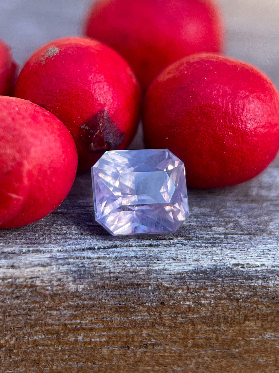 1.04 carat opalescent sapphire with a cushion cut, showcasing delicate pink to purple tones and natural untreated brilliance, sourced from Sri Lanka.
