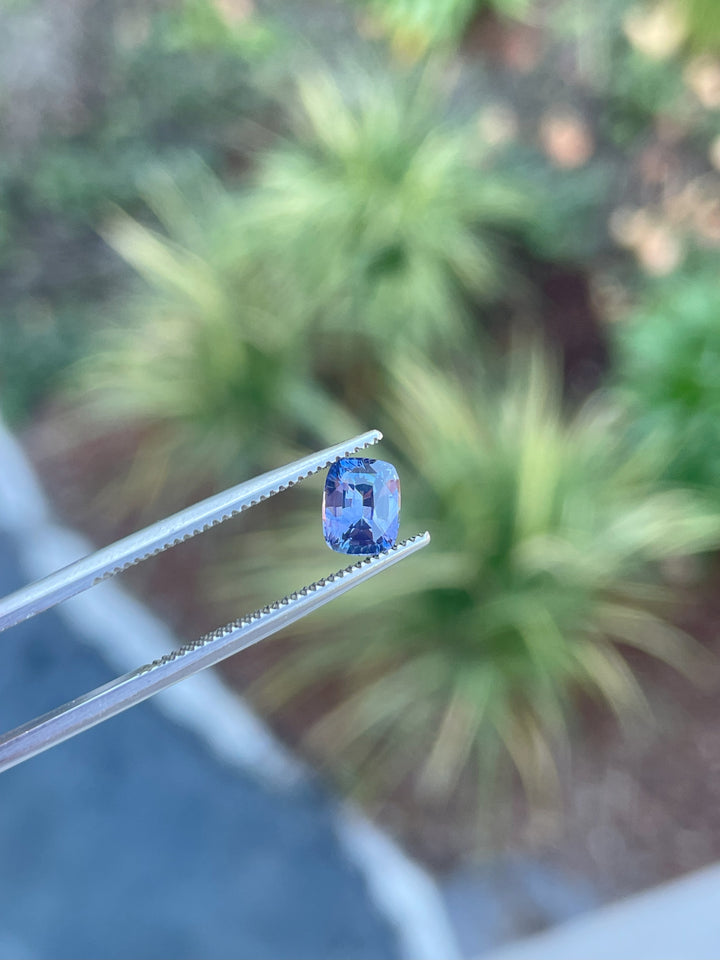 1.05 carat Sri Lankan sapphire gemstone, featuring an opalescent purple to pink hue, with a radiant cut design and untreated clarity.