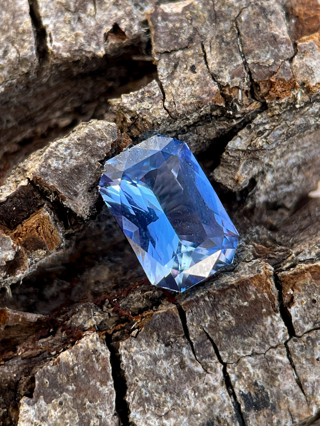 Detailed view of a 1.10 carat Sri Lankan sapphire gemstone, radiant cut, with blue and lavender hues, untreated for natural brilliance.