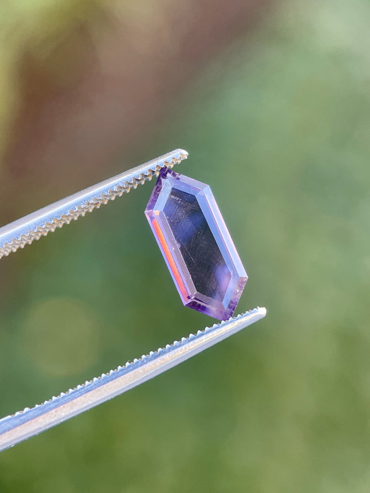 1.81 carat hexagonal step cut spinel gemstone, showcasing pink and purple tones, untreated and originating from Sri Lanka.