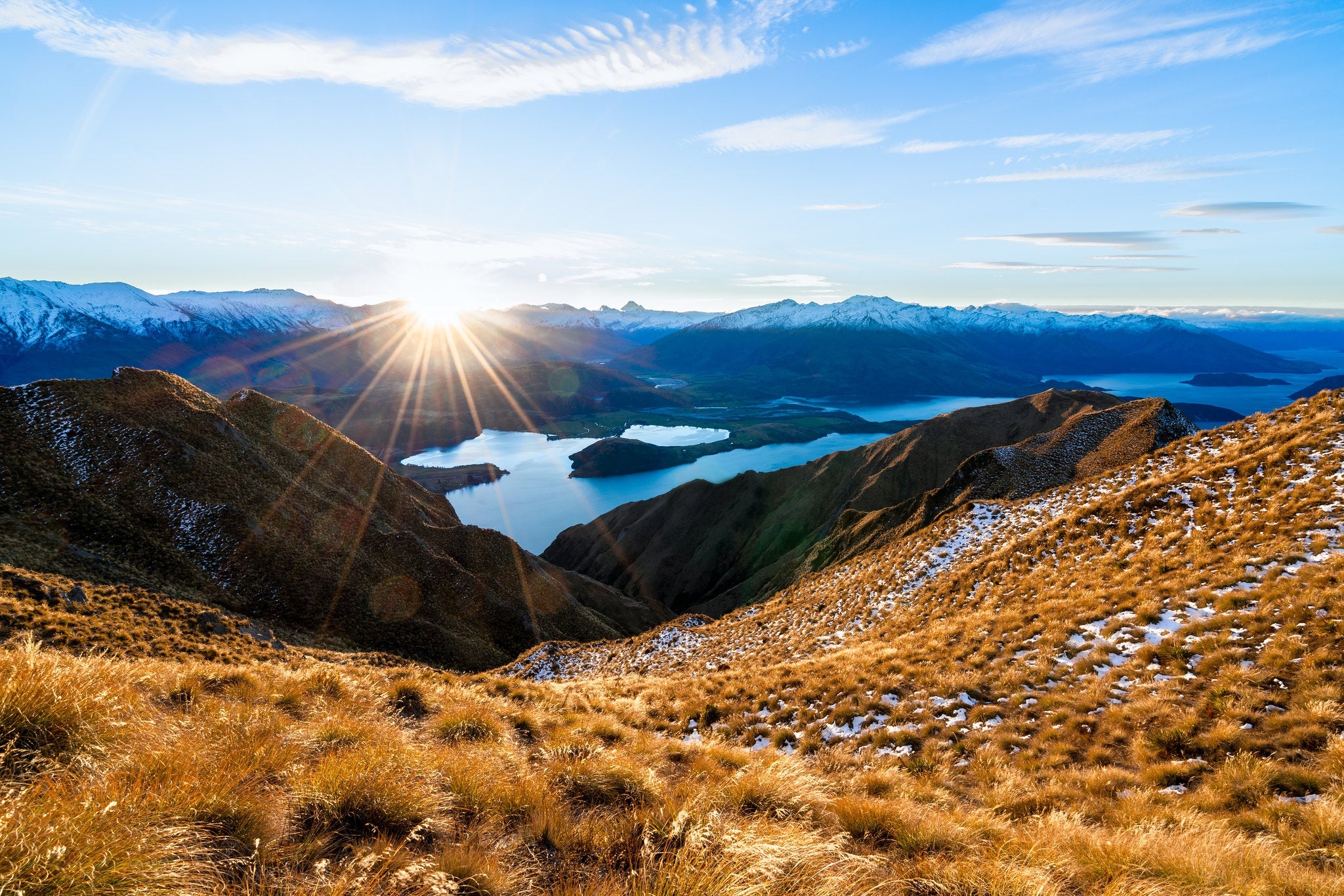 Mountain landscape at sunrise symbolizing the global sourcing journey behind rare natural gemstones and one-of-a-kind stones.