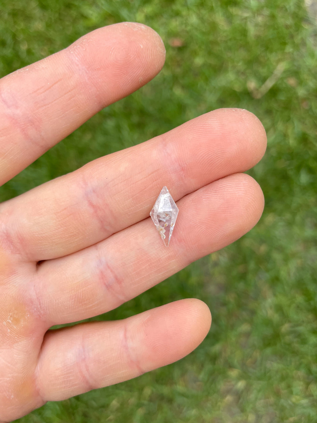 Detailed image of a silvery gray rhombohedral sapphire showing natural inclusions and clarity, weighing 2.85 carats.