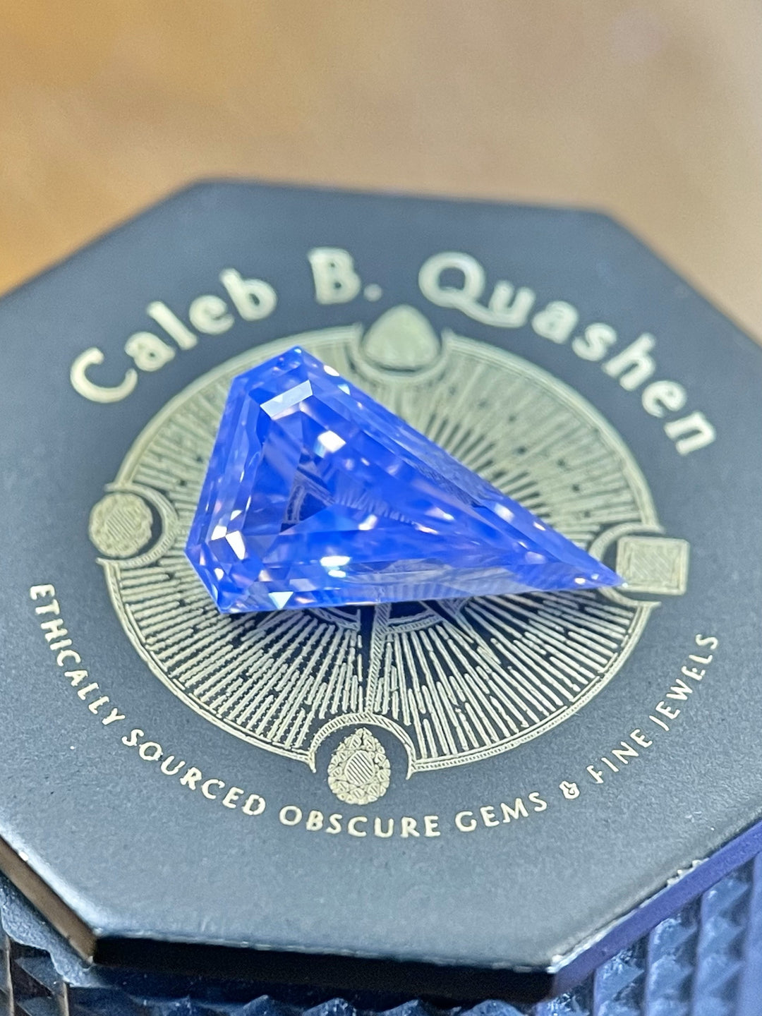 A 2.10ct fancy brown diamond resting on a luxurious black jewelry box, highlighting its elongated kite shape and flawless craftsmanship.
