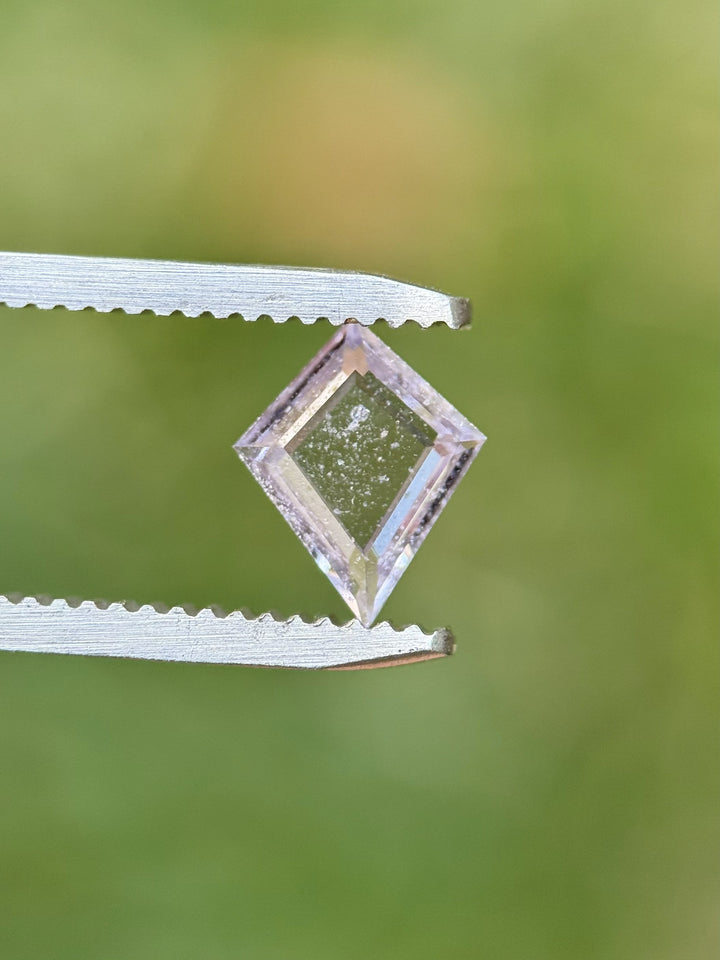 Portrait kite-cut 0.97 carat Colombian sapphire displaying soft lavender-pink tones with brilliant step facets.