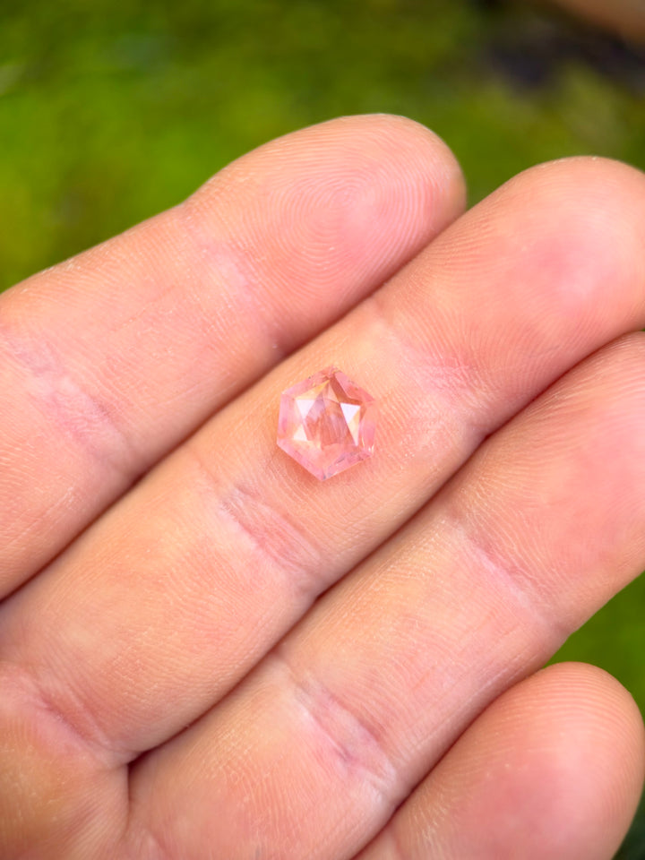 Untreated 2.67 carat opalescent padparadscha sapphire measuring 10.10 × 8.35 mm, custom cut into a low-profile hexagonal tablet shape. 