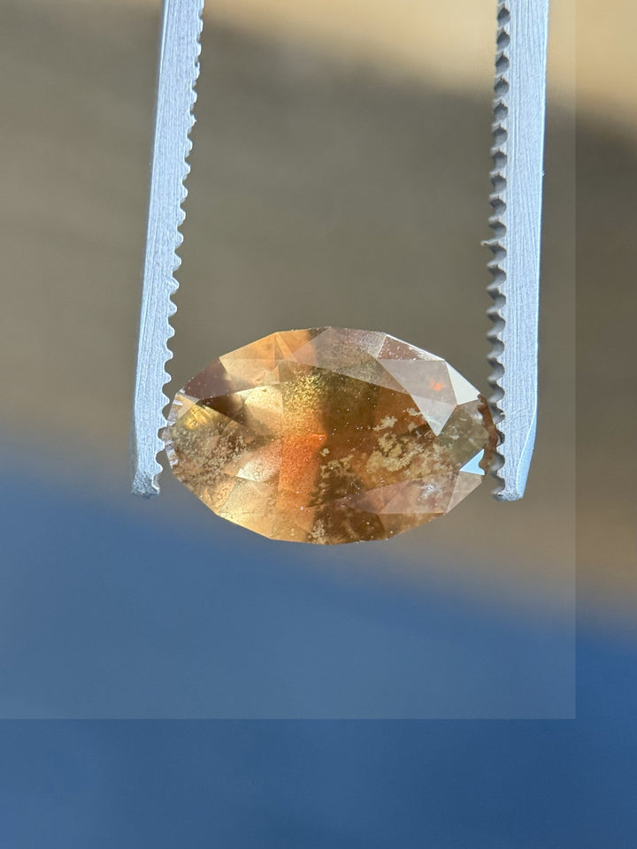 Natural 3.45ct sapphire with dramatic color shift from golden pumpkin to earthy tones, ethically sourced from Tanzania