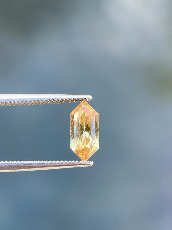 A 2.01-carat canary yellow sapphire in a modified brilliant hexagon cut, showcasing its lively and rich color. Ethically sourced from Sri Lanka with no treatments applied.