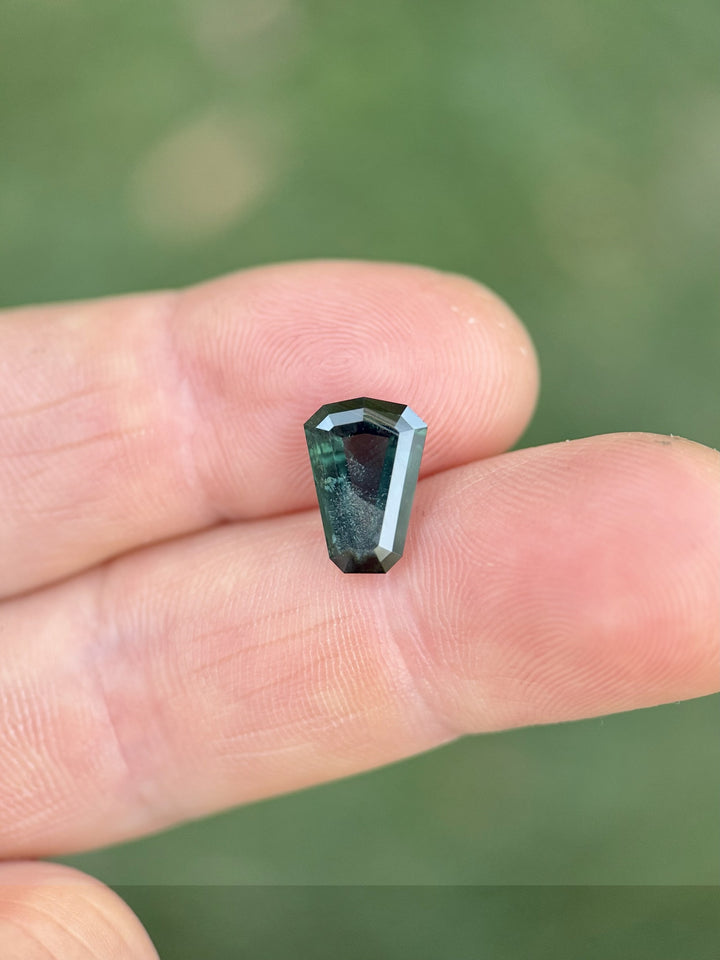 Shield-cut Kenyan sapphire weighing 3.65ct, exhibiting intense peacock coloration in a precision step facet arrangement.