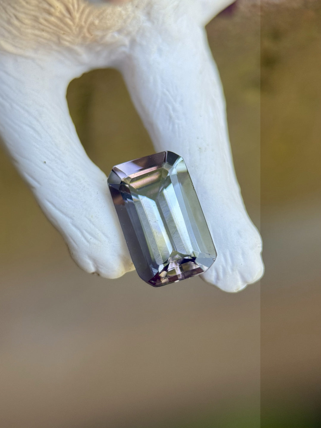 Close-up of unheated Tanzanite from Merelani Hills with pink and purple undertones on ivory background
