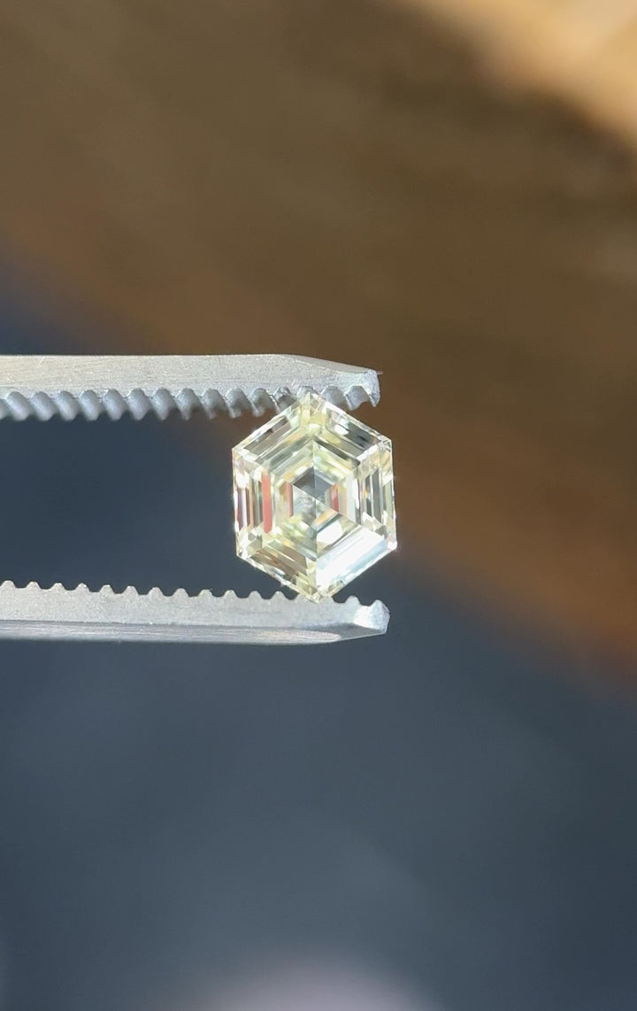 Video of a 1.01 carat O–P color VVS2 clarity diamond from Gahcho Kué, Canada, rotating in tweezers to reveal the precision of its hexagonal step cut and natural brilliance.