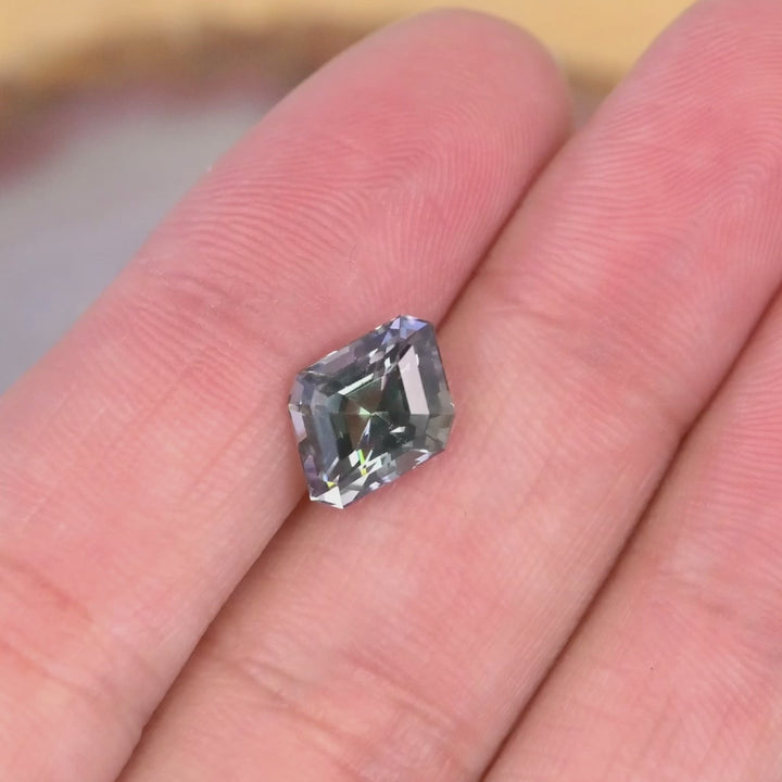 Close up video of 2.81ct Tanzanite geometric step cut displaying trichroic mermaid tones precision symmetry and high brilliance from Merelani Hills