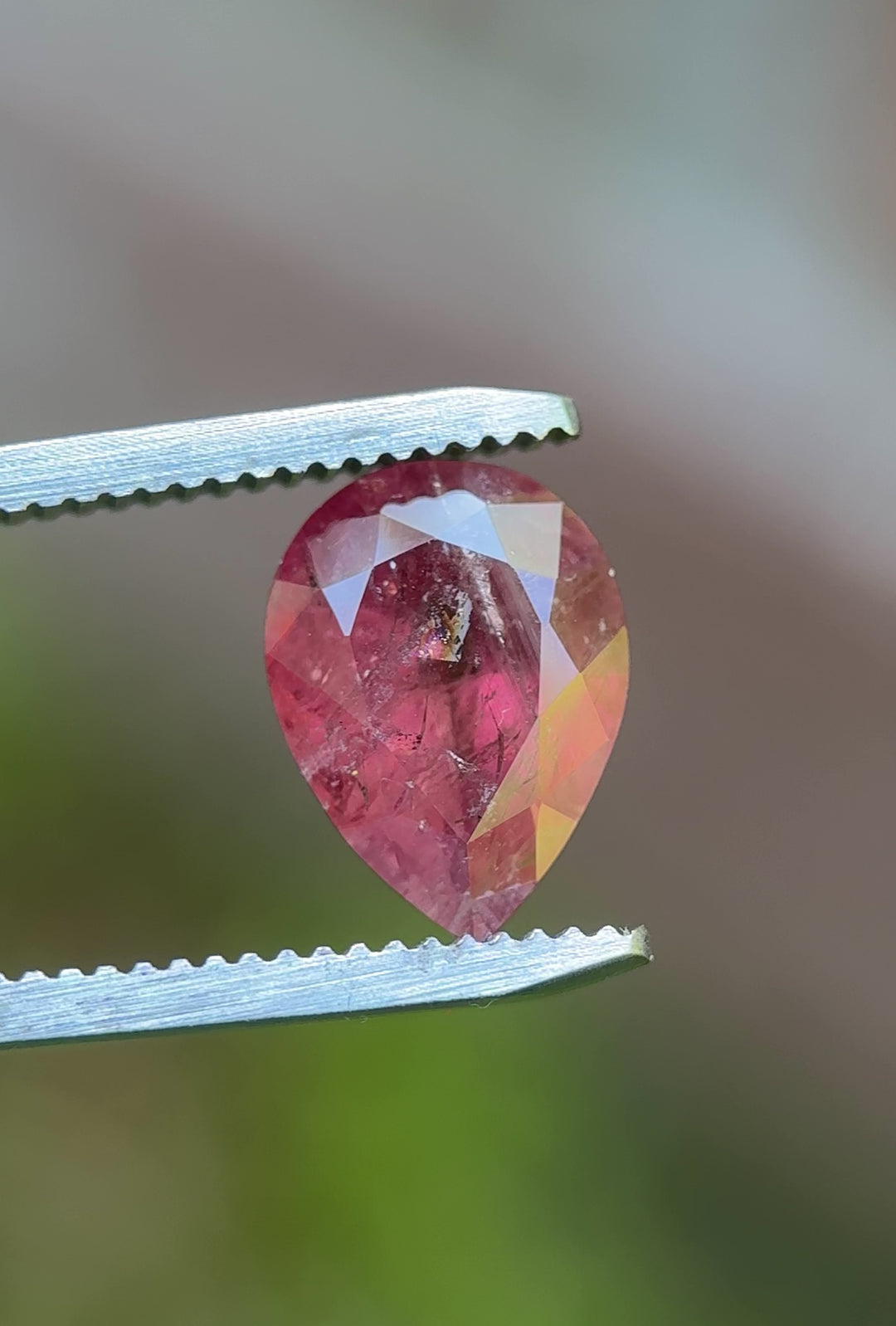 Rotating view of a 3.75ct untreated sapphire from Umba River, Tanzania, with earthy orangish red grapefruit tones and a custom pear cut