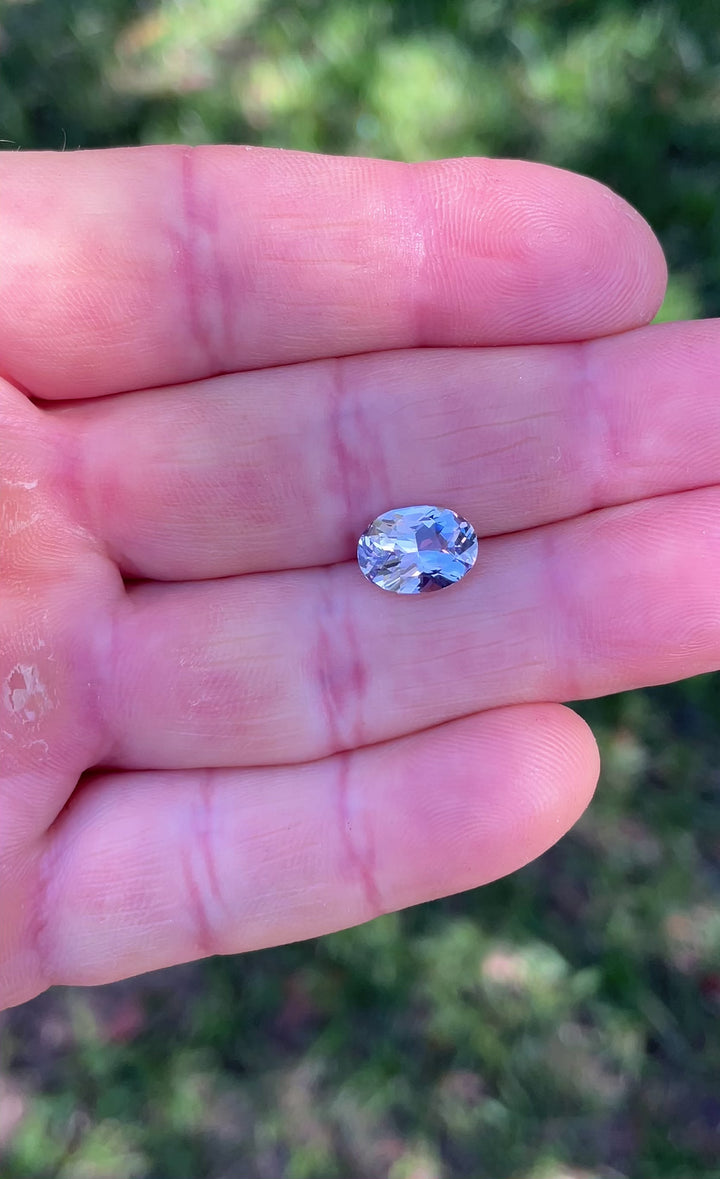 Daylight video of a 3.03 carat untreated sapphire from Madagascar, revealing a pastel mix of lavender, pink, and purple.
