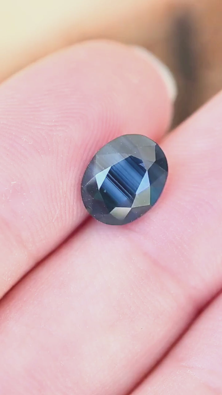 Discover the scale and distinctive blue banding of this untreated 2.98ct oval sapphire from Gombe, Nigeria. Its vivid cobalt center contrasts with deeper blue edges, creating a layered, opalescent appearance.