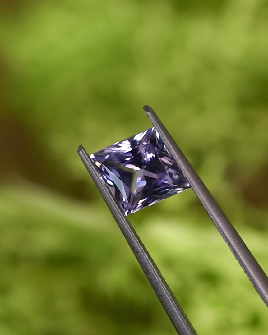 Macro video of 2.15CT gray lilac lavender sapphire rotating in tweezers, revealing its radiant brilliance and geometric symmetry in a custom kite cut, unheated gem from Sakaraha, Madagascar.