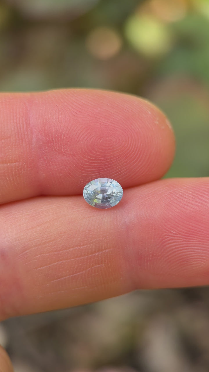 Video showing unheated 1.00ct Montana sapphire turning under sunlight, flashing teal and cornflower blue tones