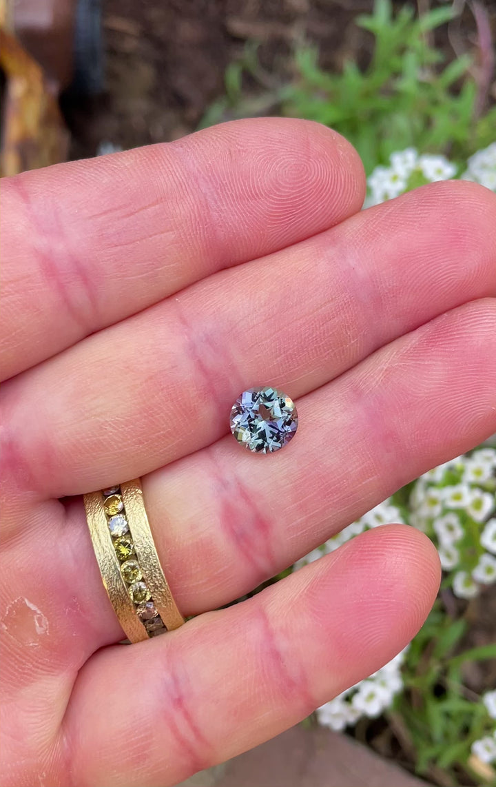 Video of a custom round Tanzanite from Merelani Hills, flashing multicolor brilliance in natural light