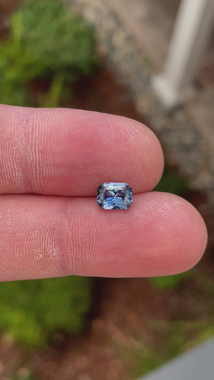 Close-up video of a radiant-cut blue sapphire, showcasing its high-quality facets and color vibrancy, origin Sri Lanka.