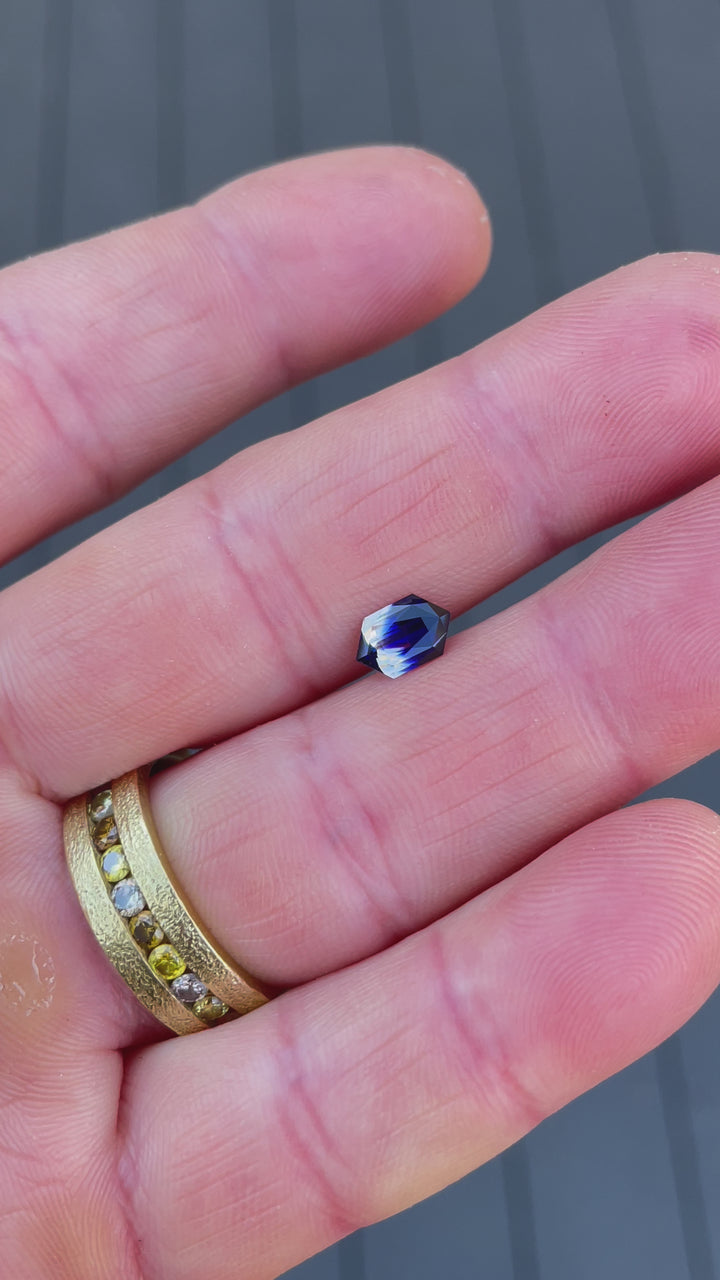 1.10-carat bi-color sapphire in royal blue and yellow with hexagon cut, displayed for brilliance and clarity.