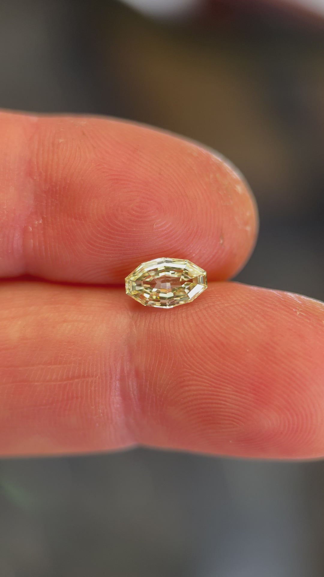 Video of a 0.99 carat light yellow diamond from Gahcho Kué, Canada, rotating under daylight to showcase its antique moval step cut, natural sparkle, and exceptional VVS1 clarity. Ethically sourced and untreated.