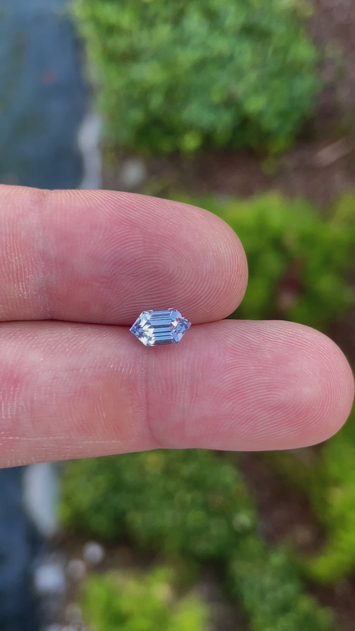 A 360-degree view of a 1.62-carat light Ceylon blue sapphire in a step-cut hexagonal shape. The video highlights the gemstone’s pristine facets, light reflection, and natural blue hue. The untreated gem, measuring 8.78mm by 5.06mm by 4.50mm, originates from Sri Lanka.