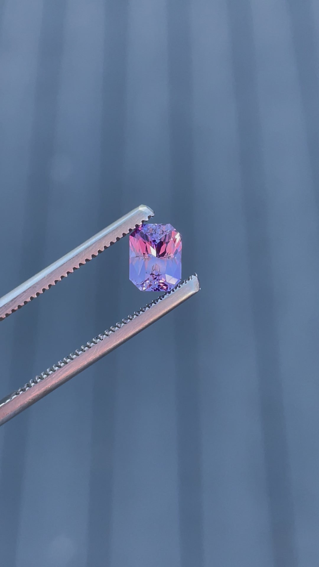 Engaging video showing a 1.05 carat pink and purple sapphire under various lighting angles, enhancing the vibrant colors and precision of the radiant cut.