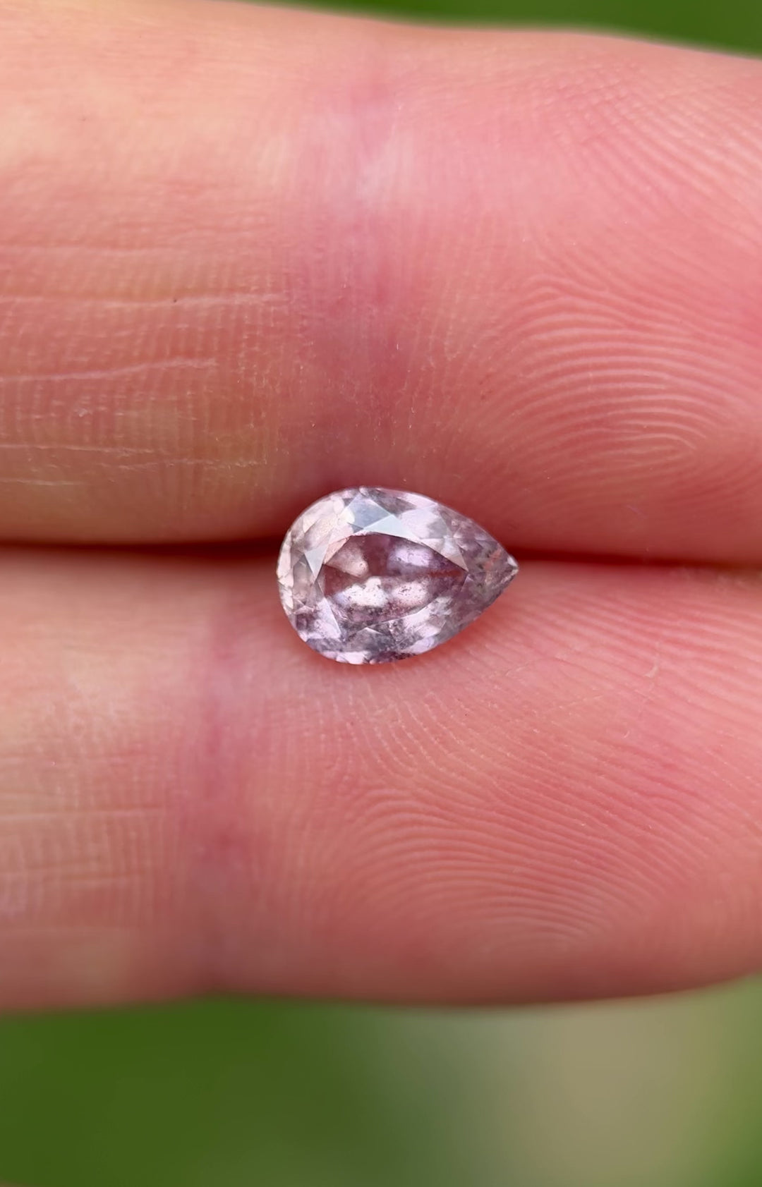 Video of a blush mauve and lavender 1.45ct Umba River sapphire in natural light, highlighting its untreated clarity and internal salt and pepper textures