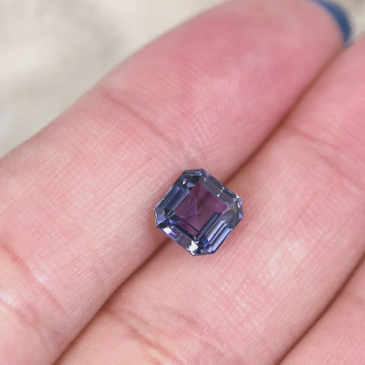 1.93 carat blue violet Tanzanite Asscher cut rotating under natural light, precision step cut gemstone from Merelani Hills Tanzania showing depth, brilliance and color saturation for custom jewelry